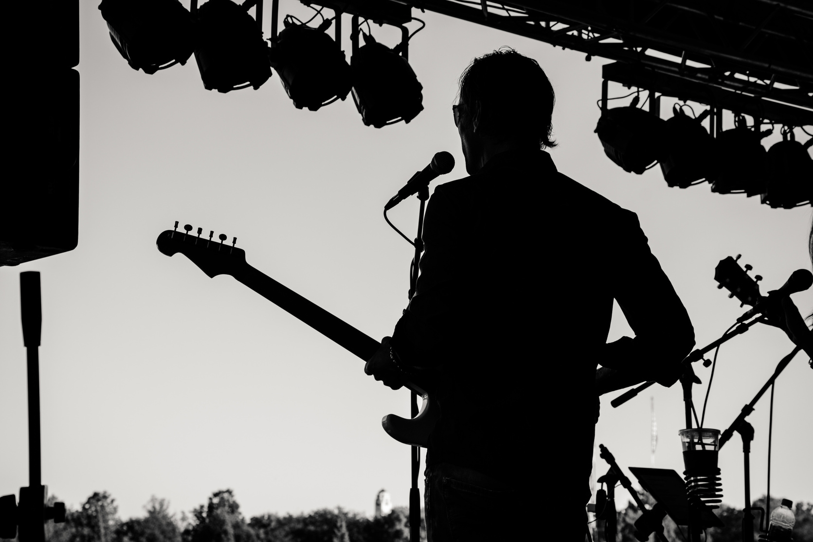 Silhouette Photo of Man Holding Guitar